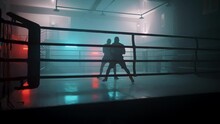 Boxer In The Boxing Gym. Bandages His Hands. Sparring In The Ring. Boxer Jumping Rope. Exercise With Ropes. Round One. Fog In The Ring. Zetsky Sport. Beautiful Backlight. World Boxing Champion.

