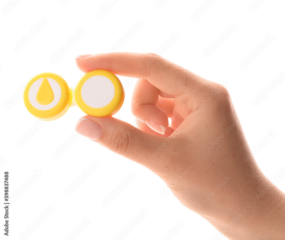 Female hand and container with contact lenses on white background