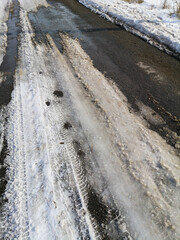 Wall Mural - The road with melting snow in nature.