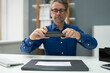 © Andrey Popov - Remote Check Deposit Using Mobile Photo. Scanning Documents