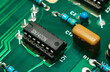 © surasak - Closeup on electronic devices on boards, background images.Colored electronic components. Resistors, transistors, capacitors and integrated circuit on PCB. Standard color code.