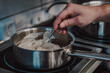 © pavel siamionov - Chef hand preparing cream sauce in pot