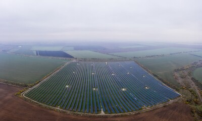 Wall Mural - Fly over a renewable solar power plant with sun in Ukraine