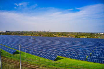 Wall Mural - Large solar power plant on a picturesque green field in Ukraine