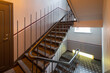 Modern interior of hall in block of flats. Entrance in residential complex. Staircase.