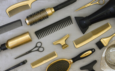 Background with gold and black hair salon accessories. Hairdressers tools, Wallpaper in trendy gray and yellow colors.