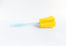 Yellow Sponge Bottle Cleaner On White Background, Simple Cleaning Tool In The Kitchen