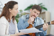 © auremar - man playing guitar with a friend