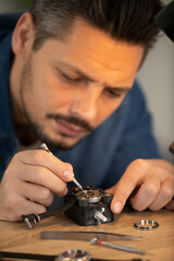 Wall Mural - close up of watchmaker repairing a watch