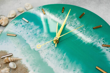 Wall clock made of resin art with sea waves and beach.