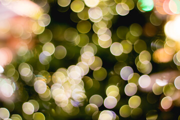 Multicolored bokeh on a dark background. Celebration atmosphere.