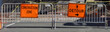 Urban construction site DETOUR sign attached to metal barricade.