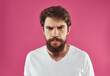 © SHOTPRIME STUDIO - Man with bushy beard on a pink background white t-shirt cropped view