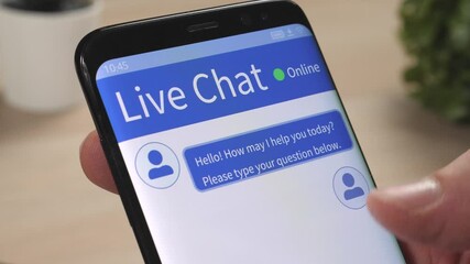 Using the live chat on a mobile phone to get support for a problem. Closeup on the smartphone screen.