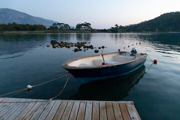  Old boat at the pier in the Mediterranean Bay in the evening