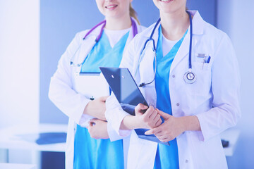 Wall Mural - Cropped shoot of two young doctors female with stethoscope.