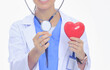 © lenets_tan - Positive female doctor standing with stethoscope and red heart symbol isolated. Woman doctor