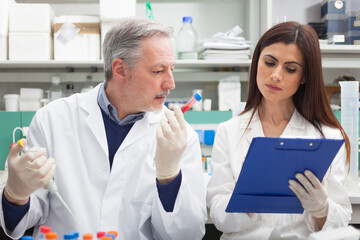 Poster - Couple of scientists at work in a laboratory