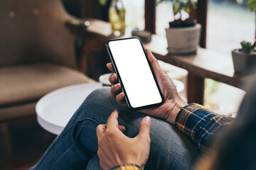 cell phone blank white screen mockup.woman hand holding texting using mobile on desk at office.backg