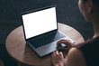 © panitan - computer screen blank mockup.hand woman work using laptop with white background for advertising,contact business search information on desk at coffee shop.marketing and creative design