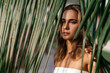 © Margo Basarab - portrait of tender woman looking out of palm leaf Bali Indonesia