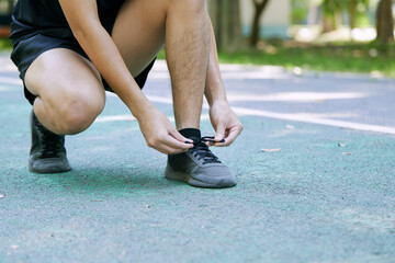 Wall Mural - Man Tying Shoelace Before Jogging