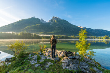 Sticker - Man overlooking hintersee lake at sunrise. Bavarian Alps on the Austrian border, Germany, Europe