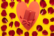 big heart in it box with ribbon. Red rose petals. Copy space. Valentines day gifts concept