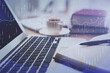© peshkova - Double exposure of financial chart drawing and desktop with coffee and items on table background. Concept of forex market trading