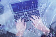 © peshkova - Double exposure of man's hands typing over laptop keyboard and forex chart hologram drawing. Top view. Financial markets concept.