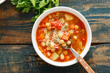 Canvas Print - Vegetables soup bowl. Tuscan tomato chickpea soup with various vegetables, thyme and parmesan cheese.