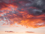 Fototapeta  - Gorgeous sunset with clouds of different shapes. Evening sky with orange, red and violet fluffy clouds. Colorful cloudscape.