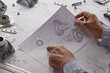 © Chaosamran_Studio - Engineer technician designing drawings mechanical parts engineering Engine.manufacturing factory Industry Industrial work project blueprints measuring bearings caliper tools