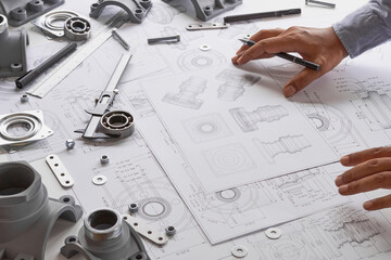 Fototapete - Engineer technician designing drawings mechanical parts engineering Engine.manufacturing factory Industry Industrial work project blueprints measuring bearings caliper tools