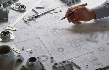 Fototapete - Engineer technician designing drawings mechanical parts engineering Engine.manufacturing factory Industry Industrial work project blueprints measuring bearings caliper tools