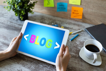 Wall Mural - tablet with blog text the on screen. social network, communication and internet marketing concept.