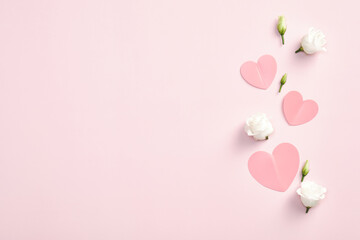 Happy Valentines Day concept. Paper hearts and rose flowers on pink background. Flat lay, top view, copy space. Valentines Day greeting card design.