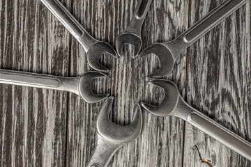 Wall Mural - Wrenches on a black wooden table. Top view.