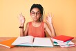 © Krakenimages.com - Young african american girl child with braids studying for school exam relax and smiling with eyes closed doing meditation gesture with fingers. yoga concept.