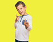 © Krakenimages.com - Adorable caucasian kid wearing casual clothes pointing fingers to camera with happy and funny face. good energy and vibes.