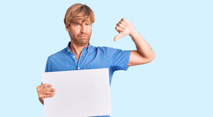 Sticker - Handsome caucasian man with beard holding sale poster with angry face, negative sign showing dislike with thumbs down, rejection concept