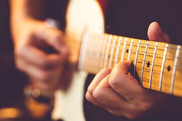 Wall Mural - Man playing electric guitar at studio.