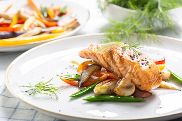 Healthy cooked Norwegian salmon served with grilled vegetables and mushrooms