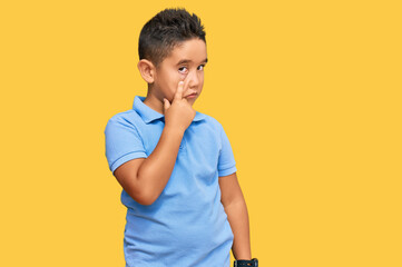 Sticker - Little boy hispanic kid wearing casual clothes pointing to the eye watching you gesture, suspicious expression