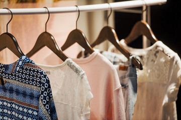 Women clothing on hangers in a mall - shopping in mall concept