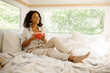 © Nomad_Soul - Young woman relax in bed, camping in a trailer