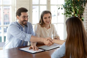 Wall Mural - Smiling male employer shake hand of female job candidate or applicant after successful interview in office. Happy man recruiter handshake get acquainted or close deal with client. Employment concept.