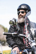 © Antonio Recena - Man in sidecar with big beard and leather jacket with parked motorcycle