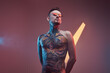 © Fxquadro - Shirtless and bearded bearded and tattooed guy with stylish hairstyle and sunglasses poses in colourful background with lights.