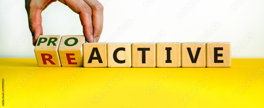 Reactive or proactive symbol. Businessman hand turns cubes and changes the word reactive to proactive. Business and reactive or proactive concept. Beautiful white background, copy space. - obrazy, fototapety, plakaty 